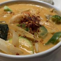 Red Curry · A thai red curry cooked with bell peppers, onions, mushrooms, baby corn, bamboo shoots, carr...
