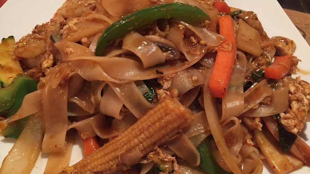 Pad Kee Mao (Drunken Noodles) · Drunken noodles. Wide rice noodles stir fry with eggs, sweet chili paste, thai basil leaves, bell peppers, onions, mushrooms, bamboo shoots, and carrots.