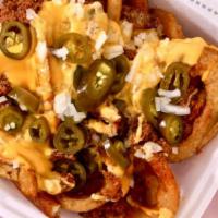 Ragnarok · Fries and torcs topped with viking sauce, cheese sauce, jalapeños, and onion.