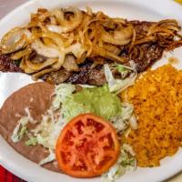 Carne Asada · Traditional thinly sliced steak. Served with rice, beans, sautéed onions, guacamole, lettuce...