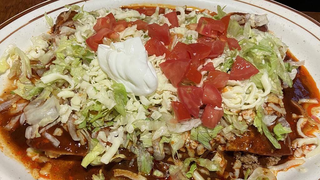 Enchiladas Ranchera · Three cheese enchiladas topped with pork cooked with tomatoes, onions, and bell peppers. Served with lettuce, guacamole, sour cream, and topped with savory enchilada sauce.
