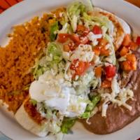 Burrito Real · Large tortilla filled with beef or chicken and topped with lettuce, sour cream, tomatoes, an...