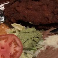 Milanesa · Breaded chicken breast or steak. Served with rice, beans, lettuce, guacamole, tomato, and to...