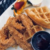 Chicken And Waffles · Belgian waffle with fried chicken strips, served with syrup and honey butter.