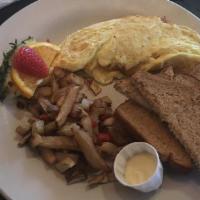 Four Egg Omelet · Served with breakfast potatoes or cheese grits and choice of bread.