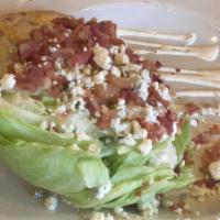 The Wedge · Baby Iceberg lettuce with creamy crumbled blue cheese and Petit Jean bacon. Add three fried ...