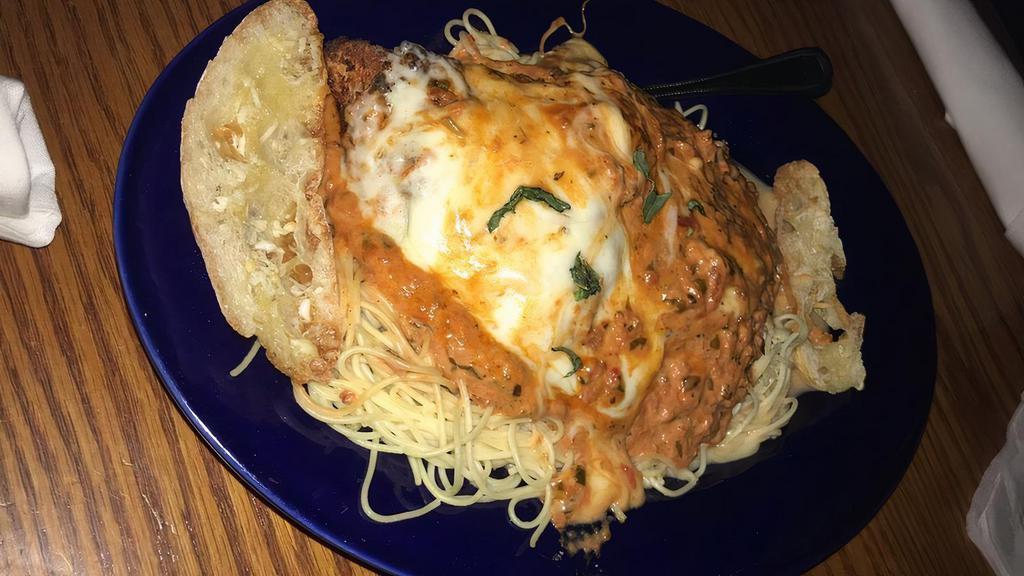Chicken Parmesan · Fresh marinara with melted mozzarella, provolone and Parmesan cheese served with capellini pasta.