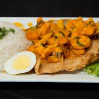 Pescado A Lo Macho · Seasoned fried fish fillet topped with mussels, calamari and shrimp in a zesty sauce, served...