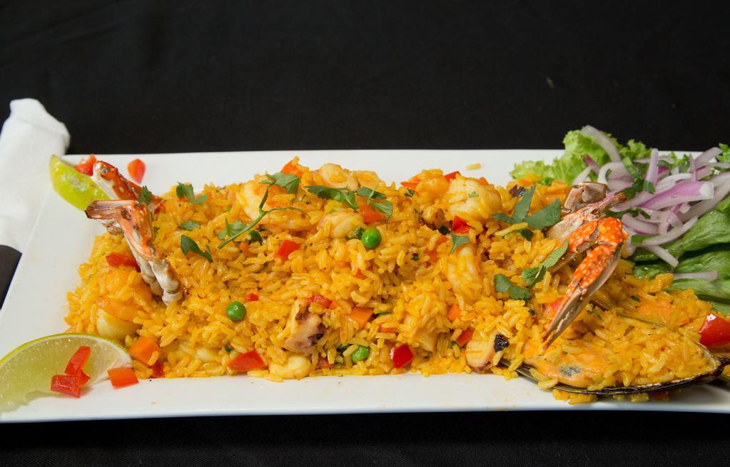 Arroz Con Mariscos · A mixture of clams, mussels, shrimp and scallops and yellow rice.  (Suggested Wine: Tempranillo/Chardonnay)