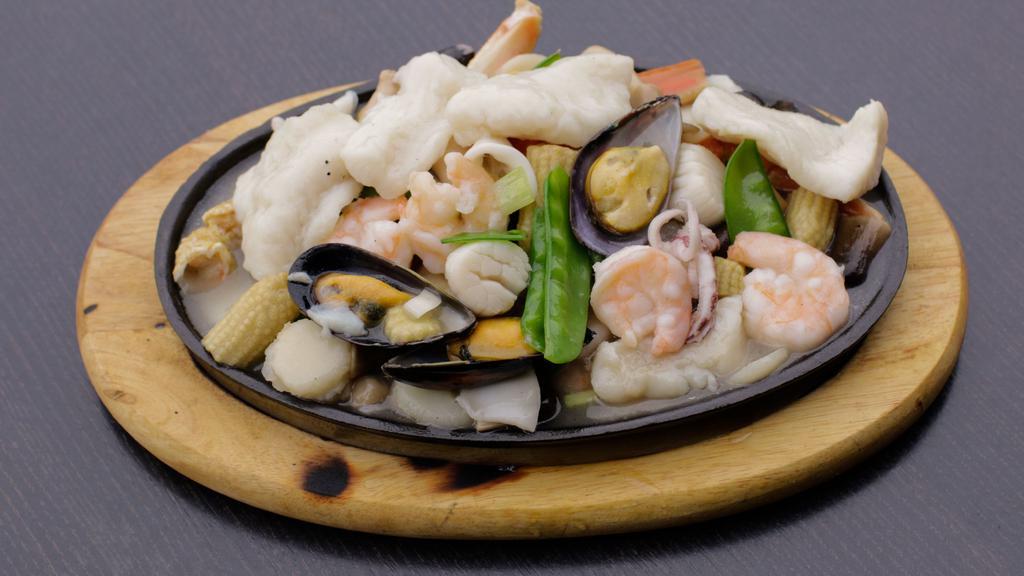 Seafood Combination · Lobster meat, shrimp, crab meat, and scallop with vegetable in tasty white sauce with rice.