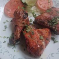 Tandoori Chicken · (Leg quarter pieces in one order). Tender bone-in chicken marinated in yogurt, blend of spec...
