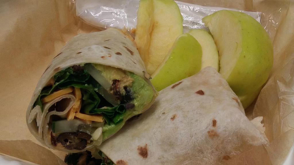Veggie Wrap · Served with roasted red pepper hummus, avocado, cucumber, black olives, spinach, sun-dried tomatoes, and cheddar cheese wrapped in a flour tortilla.