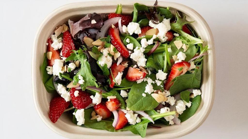 Strawberry Fields Salad · Farm greens, fresh strawberries, shaved red onion, sliced almonds, goat cheese and fresh mint with a balsamic vinaigrette