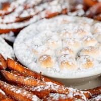 Sweet Potato Fries · – served with marshmallow caramel fosters
sauce, powdered sugar