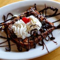 Brownie A La Mode · Warm chocolate chip brownie served with a scoop of ice cream and chocolate or raspberry sauce.