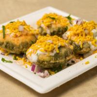 Spdp · Savory puffed flour crisp (puris) stuffed with potatoes, onions, cilantro, and crunchy chick...