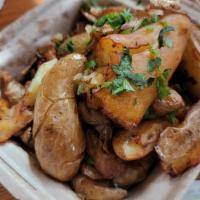 Masala Smashed Potatoes · Crispy fingerling potatoes tossed with salt, chaat masala, lime juice and cilantro. Served w...