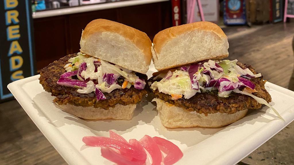 Impossible Burgers · Impossible Burger seasoned with cumin, ginger, mint, cilantro. Served on pav with green chutney, Maggi ketchup, and desi slaw. The vegan option will have pickled red onion instead of desi slaw. Needs modifier that allows the item to be made vegan please.