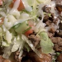 Carne Asada Fries · Fries top with steak, queso dip, guacamole, lettuce, tomatoes, onions, and pickled jalapeños.