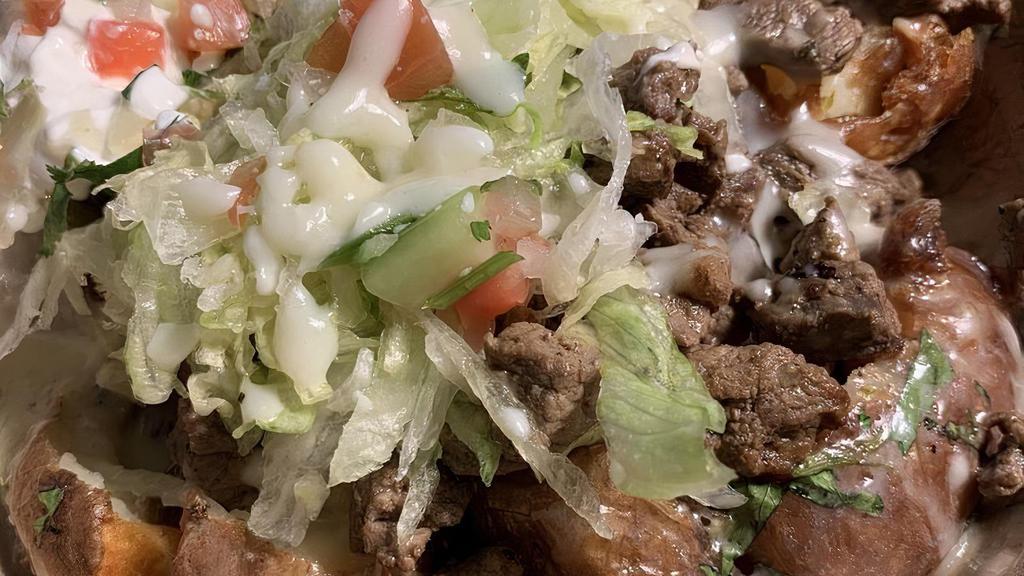 Carne Asada Fries · Fries top with steak, queso dip, guacamole, lettuce, tomatoes, onions, and pickled jalapeños.