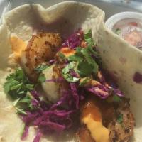 Shrimp Taco · Topped with red cabbage, Pico de Gallo, spicy chipotle sauce, and honey mango.