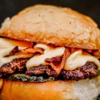 Cheesy Burger · Single 3oz patty with house pickles, bacon and cheese sauce.