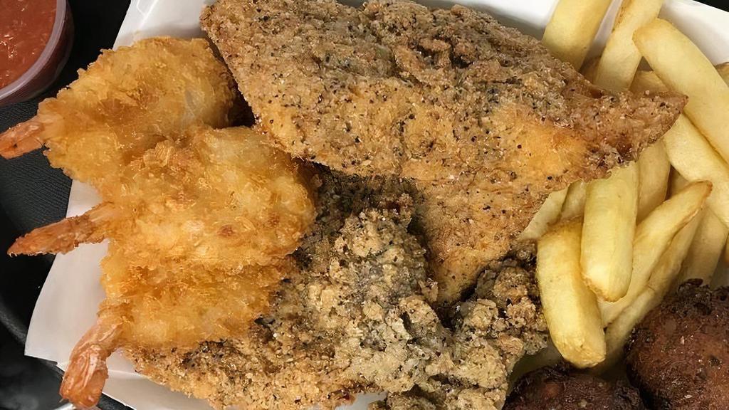 Seafood Dinner With A Side Of Cole Slaw · 2 pieces of our hand-filleted, hand-breaded Cod, fried butterfly shrimp, pan fried  oysters, cole slaw and 2 hushpuppies plus 1 side, premium side additional charge.