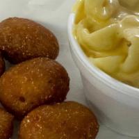 Kids Mini Corn Dogs · Little bits of breaded hot dogs, served with a side and a drink. (Shown with mac n cheese).