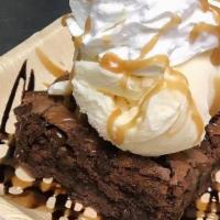 Brownie · Our Brownie MADE WITH NUTS, drizzled in chocolate topped with our house made whipped cream.