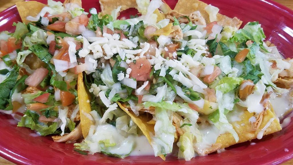 Supreme Nachos · Ground beef or chicken topped with cheese, lettuce, sour cream and pico de gallo.