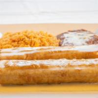 Chimichanga Dinner · Two Chimichangas, beef or chicken, fried or soft, and covered with queso dip.  served with r...