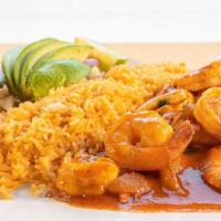 Camarones A La Diabla · Sautéed shrimp with a red spicy sauce. Served with rice lettuce, tomatoes, and sour cream.