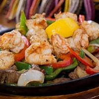 Shrimp Fajitas · Served with rice and beans, lettuce, sour cream, guacamole, pico de gallo, and your choice o...