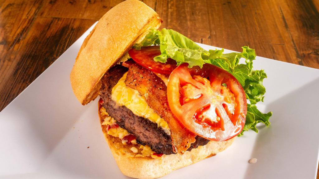 Bacon Pimento Cheese Burger · Honey glazed pepper bacon, jalapeño, and regular pimento cheese, lettuce, and tomato. Certified Angus beef patties. Served on a grilled slightly sweet sourdough bun with your choice of a side.