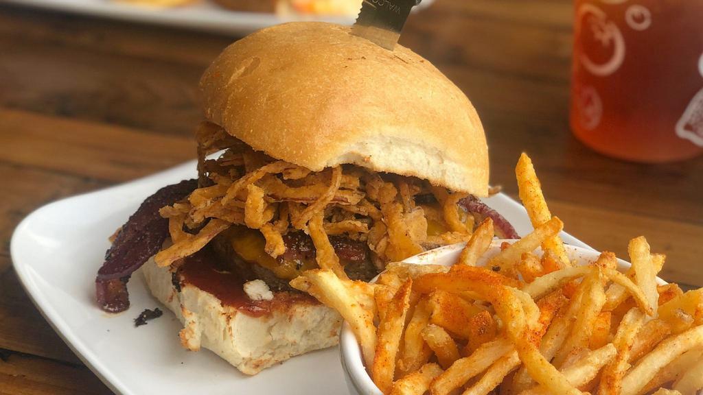Cowboy Burger · Topped with BBQ sauce, honey glazed pepper bacon, fried onion straws, and cheddar cheese.
