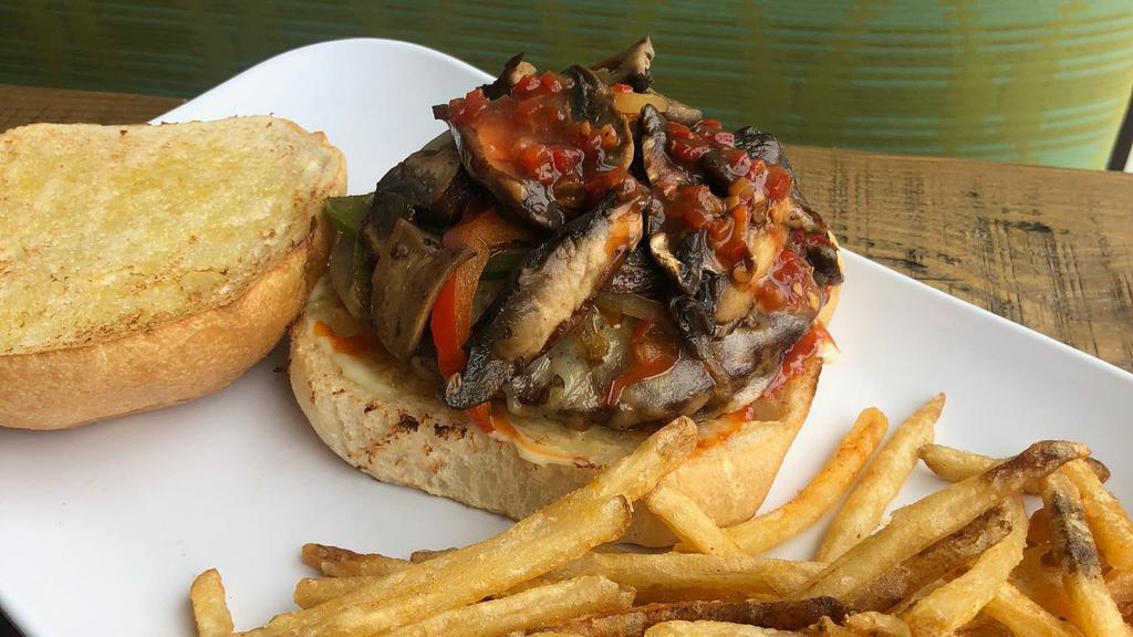 Mushroom & Swiss Extravaganza Burger · Sauteed peppers, onions and mushrooms, red pepper relish, chipolte ketchup, mayo and Swiss cheese.