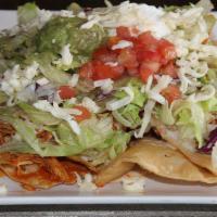 Special Nachos · Tortilla chips topped with beef or chicken, lettuce, tomato, sour cream, guacamole, and nach...