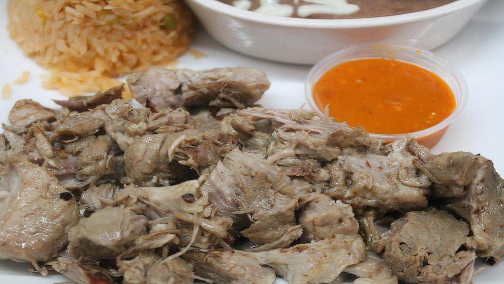 Carnitas · 10 oz. seasoned pork sliced into chunks and slow-cooked which originated from the state of Michoacán, Mexico. Served with rice and beans, lettuce, tomato, sour cream, tomatillo sauce, and your choice of corn or flour tortillas.