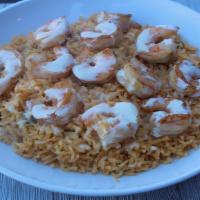 Arroz Con Camarones · Plump grilled shrimp served on a bed of rice with cheese dip on top.