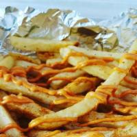 Coop Fries · Seasoned with old bay and topped with coop sauce (spicy sauce).