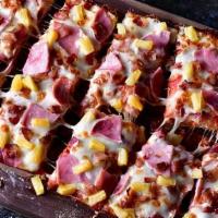 Hawaiian · Pizza sauce, premium mozzarella, ham, bacon & pineapple.