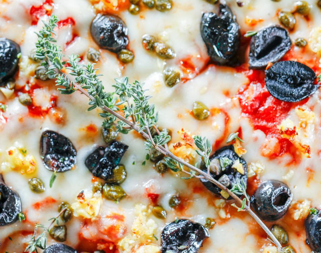 Sicilian · Fresh herbs, black olives, capers, roasted garlic, Grana Parmesan, mozzarella, and our authentic pizza sauce.
