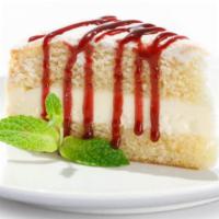 Crème Cake · Three layers of rich lemon cake and mascarpone cheese filling, served in a pool of raspberry...