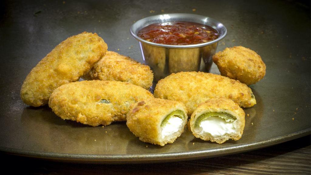 Jalapeño Poppers · Fresh golden-crispy poppers filled with cream cheese and fried. Served with ranch.