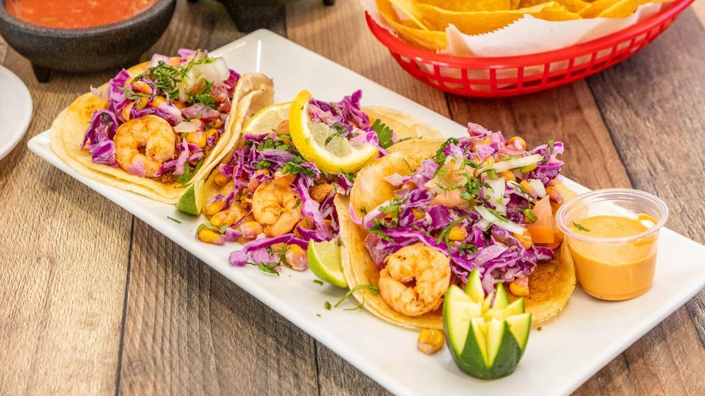 Californian Tacos · Three soft corn tortilla tacos with shrimp (imported) or fish, topped with cabbage, pico de gallo, lime chipotle dressing, and a side of rice.
