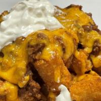 Loaded Tater Tots · Tots topped with chili, cheddar cheese and sour cream.
