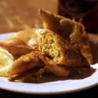 Palace Samosas (Vegan*) · Two fried triangle shaped pastries stuffed with sauteed spices.