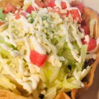 Taco Salad · A fried tortilla shaped like a bowl, filled with ground ground beef or shredded chicken. Top...