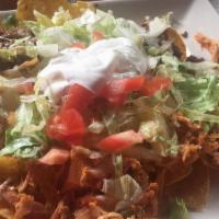 Nachos Supremos · Chips topped with seasoned ground beef, shredded chicken, refried beans, shredded cheese, an...