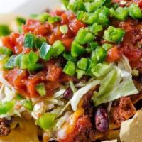 Steakhouse Nachos · Fresh tortilla chips layered with chili and melted cheese, topped with lettuce, salsa, and j...